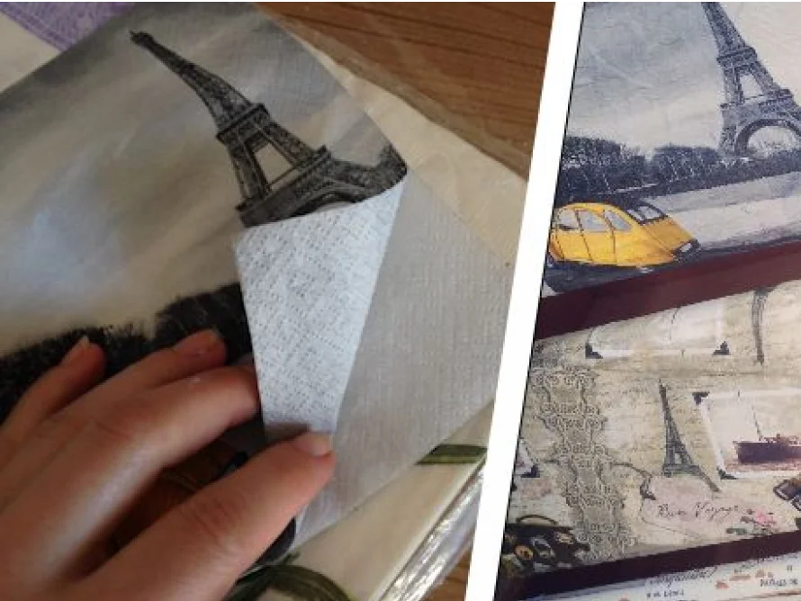 Hand faltet Serviette mit Eiffelturm-Motiv