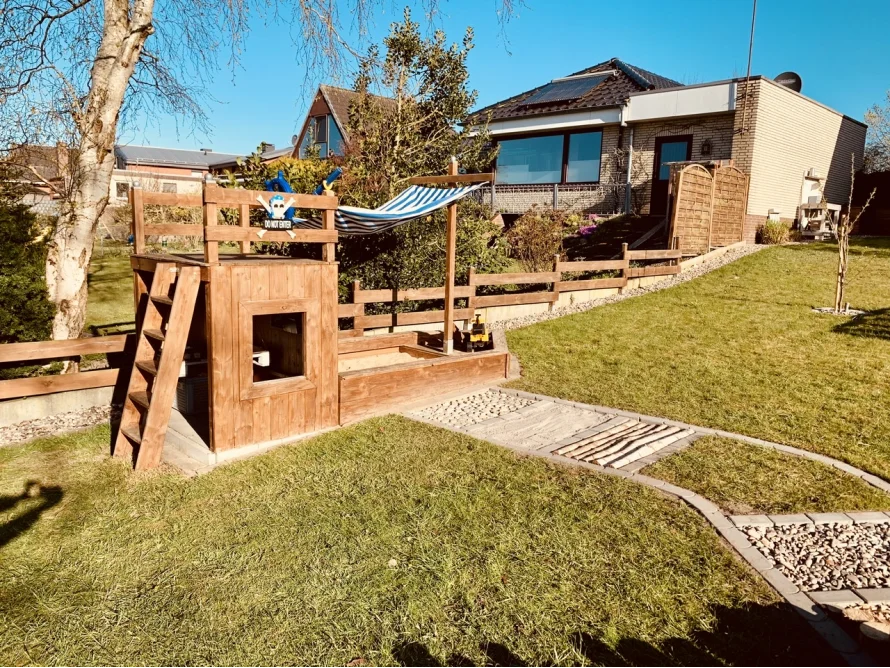 Spielhaus aus Holz mit Sandkasten