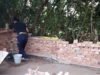 Person mauert eine Ziegelwand