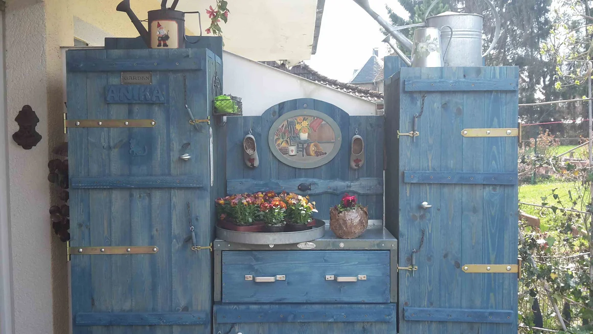 Blauer Gartenschrank mit Blumen