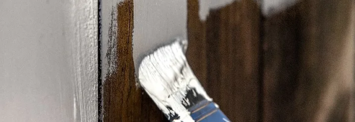 Holzzaun wird weiß gestrichen