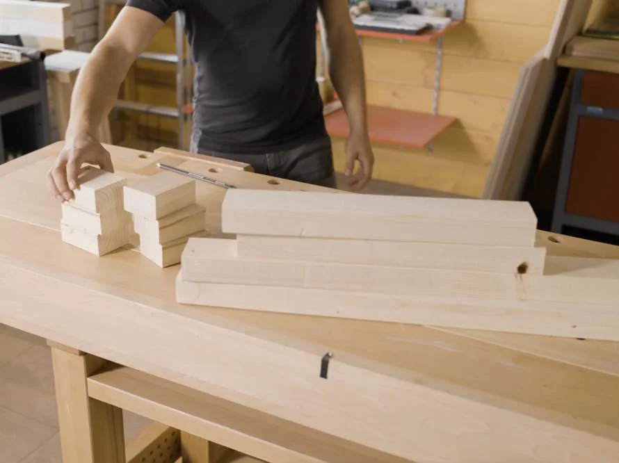 Person und zugeschnittene Holzbretter