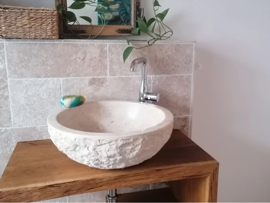 Waschbecken aus Stein auf einem Holztisch