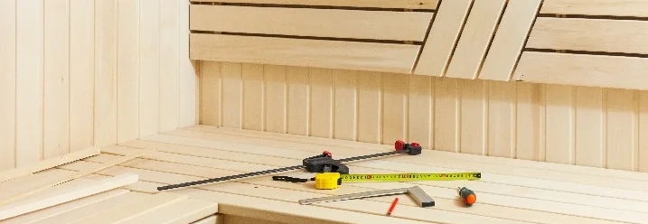 Saunabau mit Zollstock und Bleistift