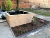Neu angelegter Gartenteich mit Holzumrandung