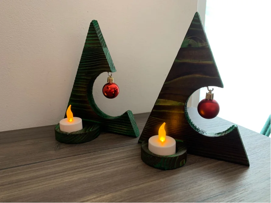 Zwei grüne Holz-Weihnachtsbäume mit Kerzen und Kugeln