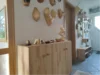 Ein Flur mit einem Sideboard und Dekorationen aus Holz.
