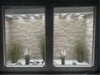Fensterbank mit Dekogras und Steinen