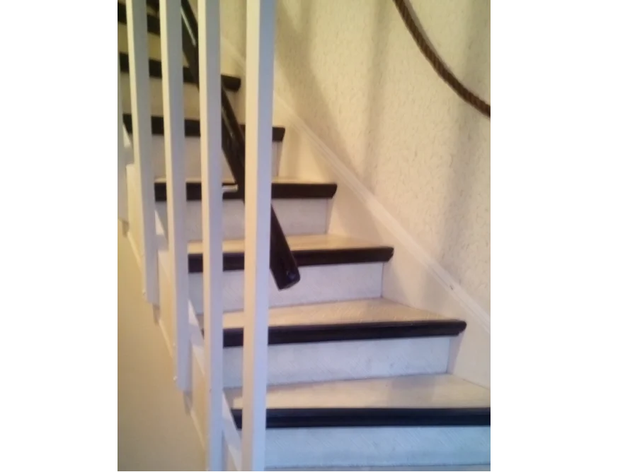 Weisse Holztreppe mit schwarzem Geländer