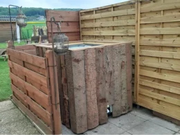 Gartenhaus aus Holz mit Laternen.