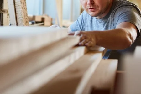 Person bearbeitet Holz