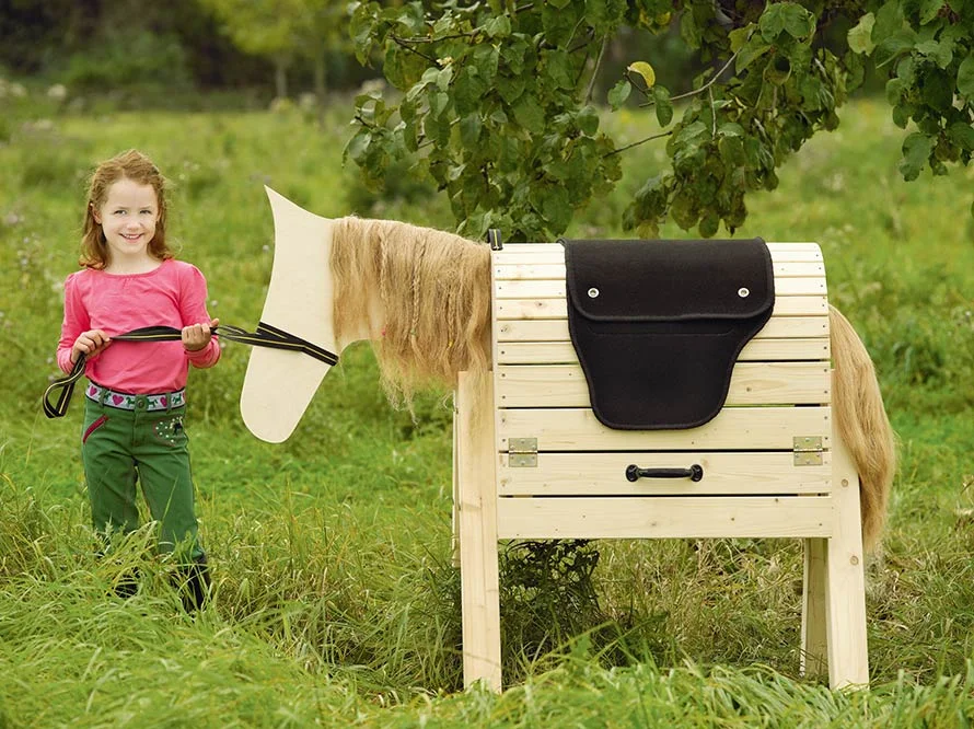 Kind mit selbstgebautem Spielpferd aus Holz