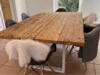 Holztisch mit Stühlen und Fellen