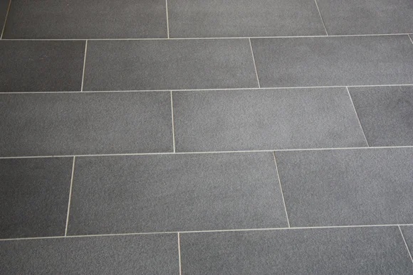 Grauer Fliesenboden mit beigefarbener Fuge