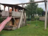 Holzspielplatz mit Rutsche und Schaukel