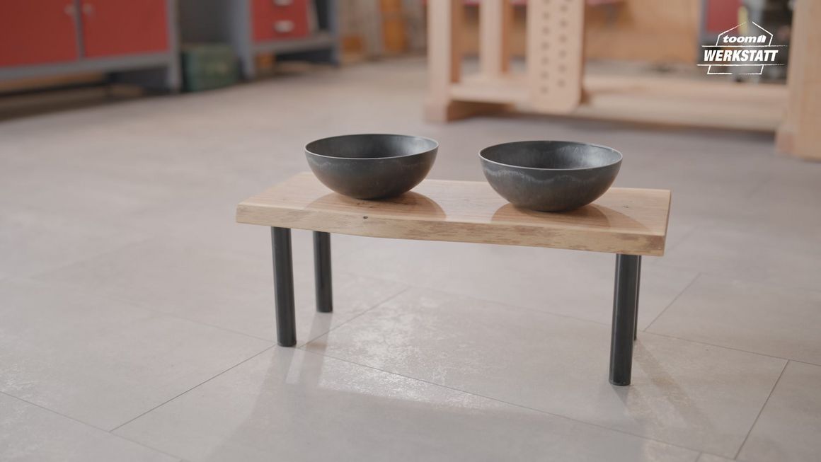 Zwei Futternäpfe auf einem kleinen Holztisch