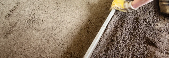 Person zieht Estrich glatt