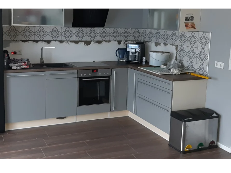 Graue Küche mit Backofen und Mülleimer