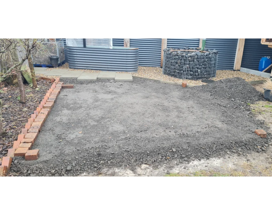 Gartenfläche mit Kies und Ziegelsteinen