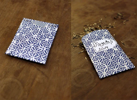 Zwei Samentüten mit blauem Muster auf Holztisch