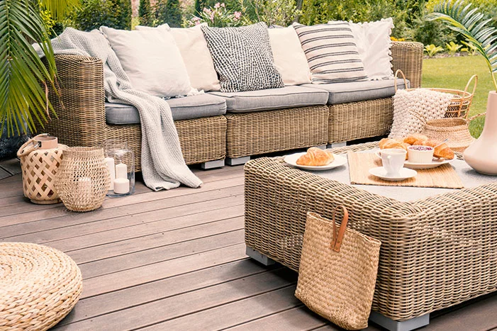 Gemütliche Lounge-Sitzecke aus Rattan auf einer Terrasse