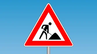 Baustellenschild mit Person und Schaufel