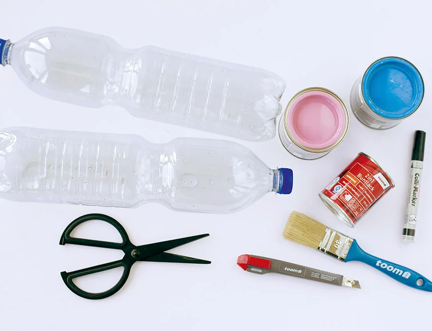 Bastelmaterial: Zwei Plastikflaschen, Farbe und Werkzeug