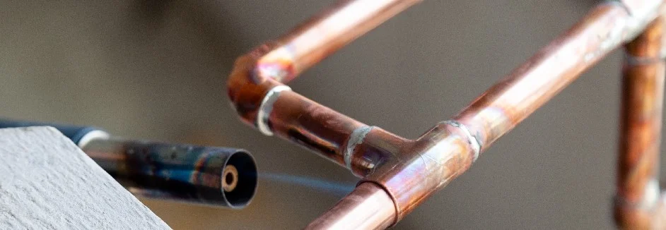 Kupferrohre werden mit einem Gasbrenner gelötet.
