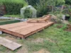 Holzterrasse am Gartenteich mit Liege