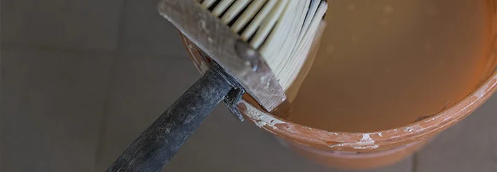 Pinsel und Eimer mit Farbe