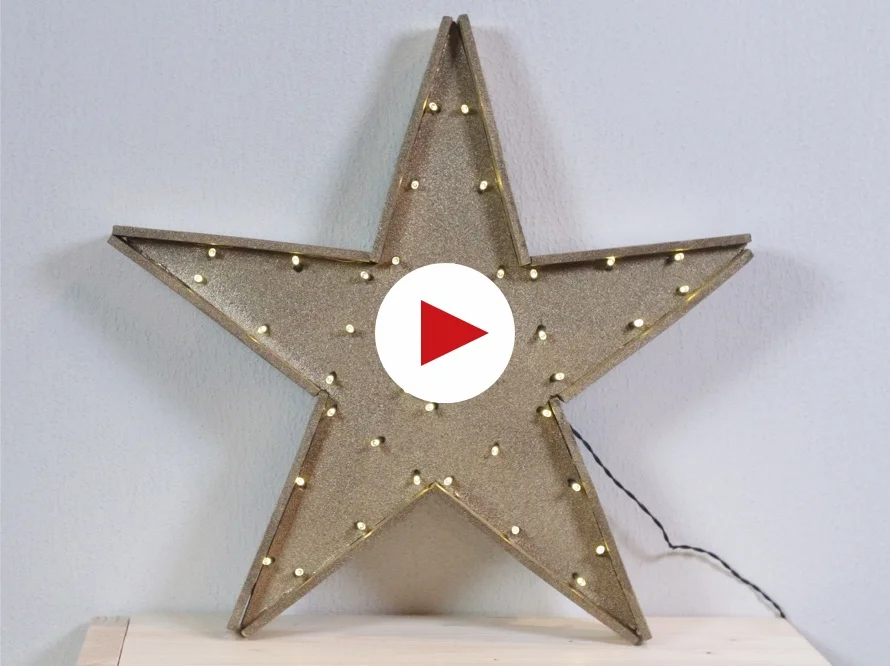 Goldener Stern mit Lichtern und Play-Button