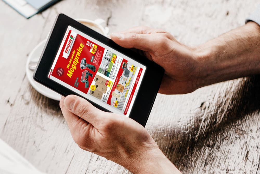 Eine Person schaut sich einen digitalen Baumarkt-Prospekt auf einem Tablet an.