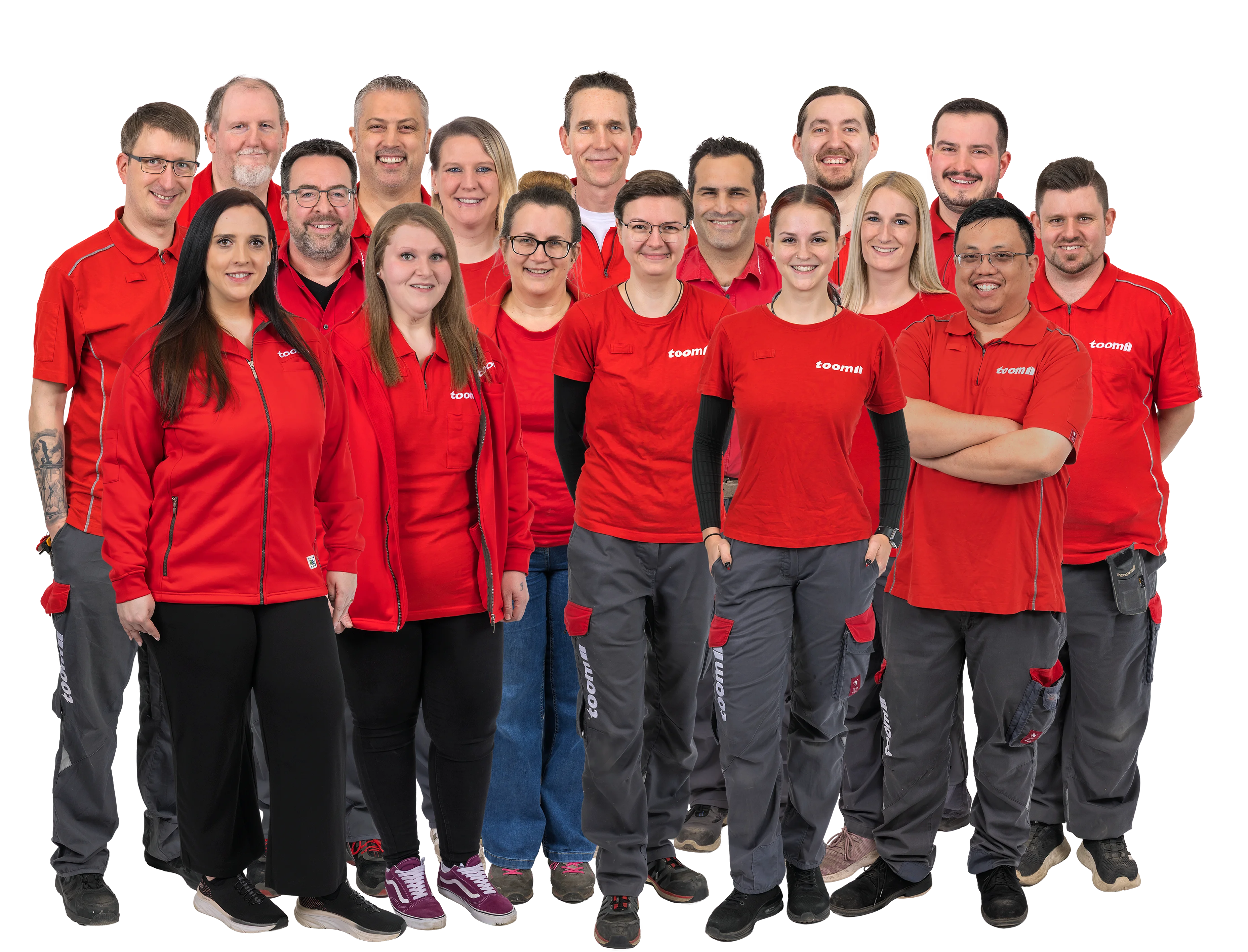 Gruppenbild eines Teams in roter Arbeitskleidung vor schwarzem Hintergrund.