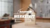 toom Werkstatt Logo mit unscharfem Vogelhaus im Hintergrund