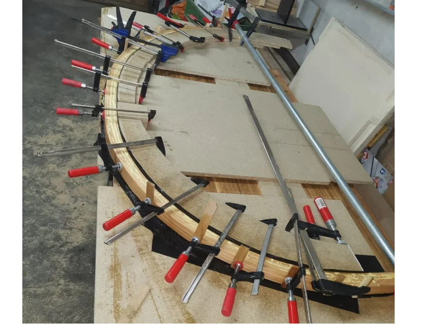 Gebogenes Holz wird mit Schraubzwingen fixiert