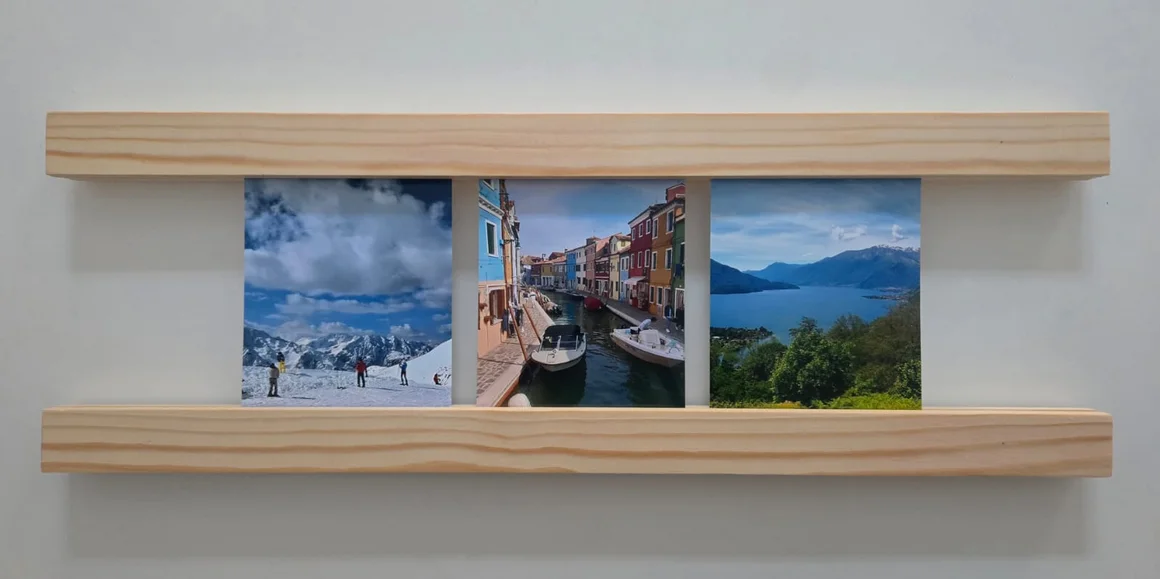 Eine Bilderleiste aus Holz mit drei Landschaftsfotos.