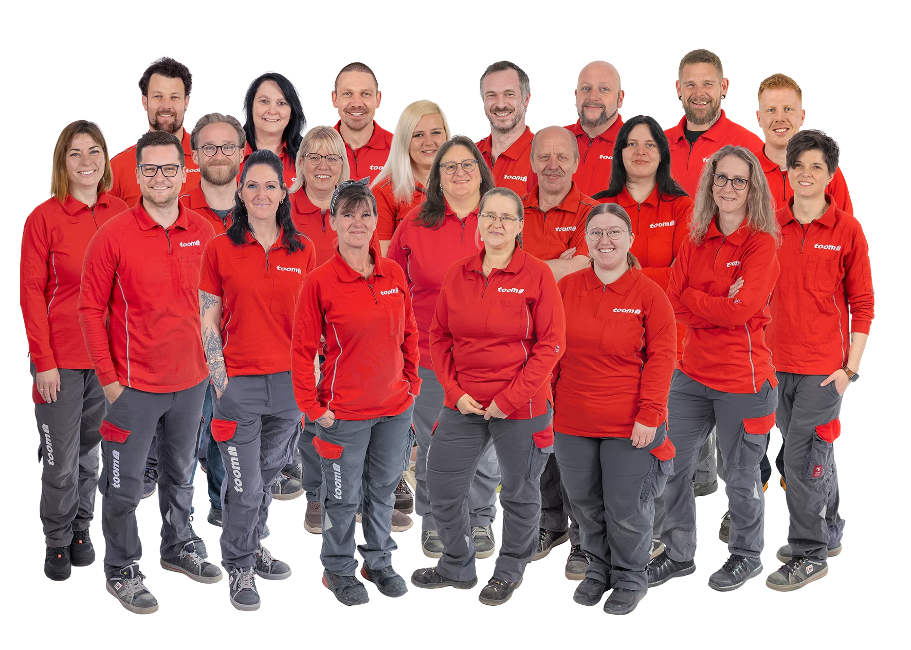 Gruppenfoto eines Teams in einheitlicher Arbeitskleidung vor schwarzem Hintergrund.