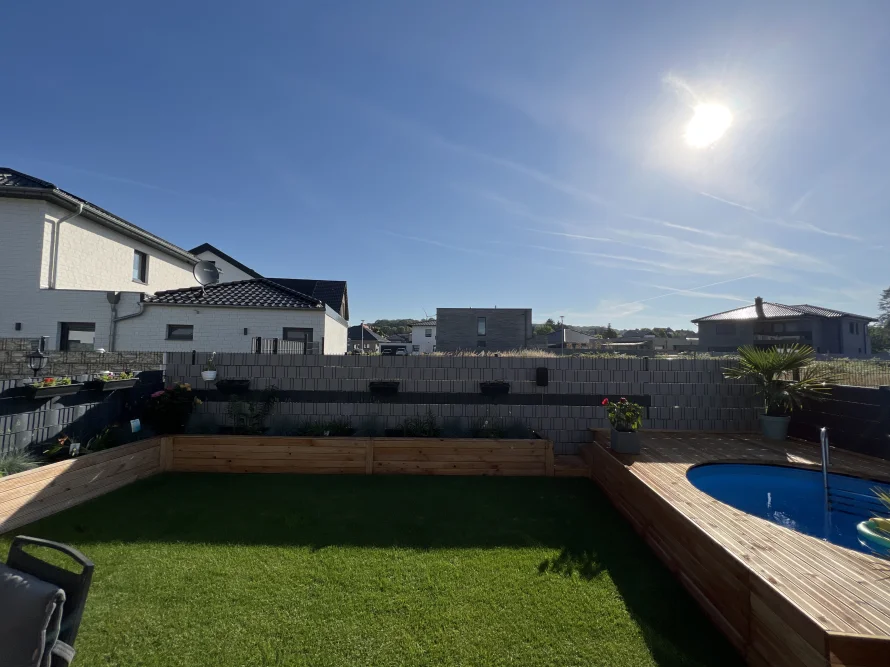 Garten mit Pool an sonnigem Tag