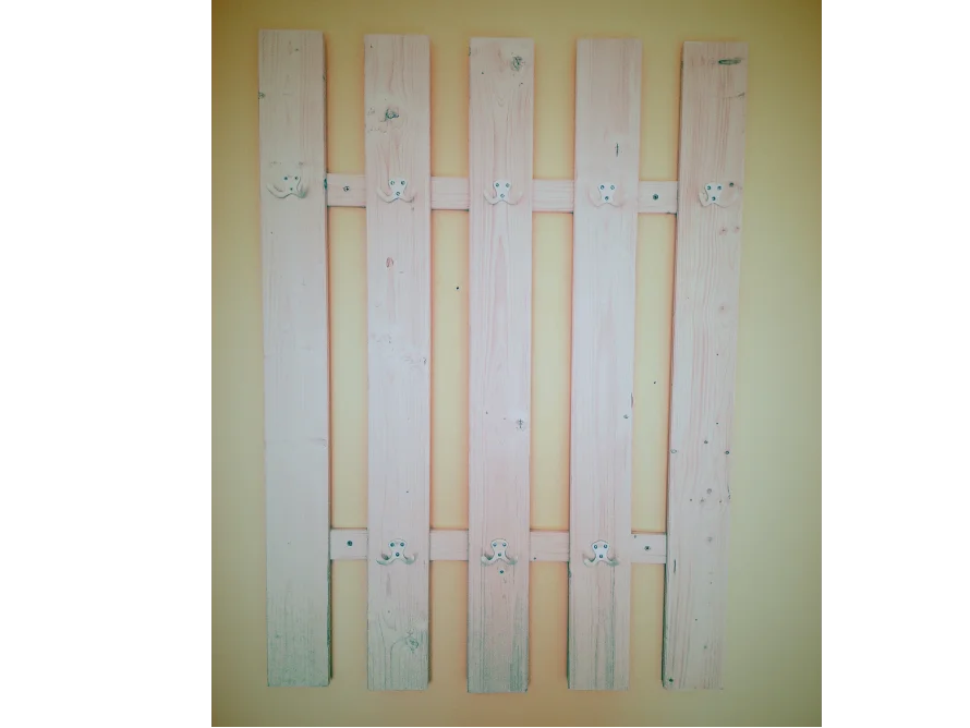 Holzzaun an gelber Wand