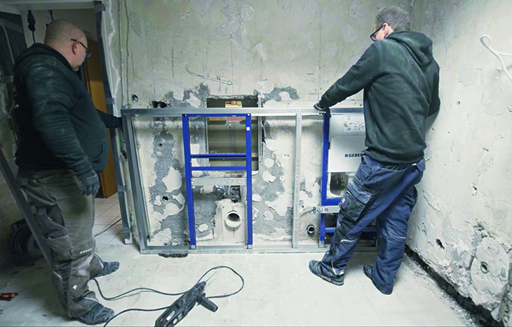 Zwei Männer richten das Vorbauelement aus.