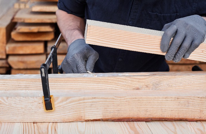 Nahaufnahmen von Händen die Holzleim auf Holz auftragen