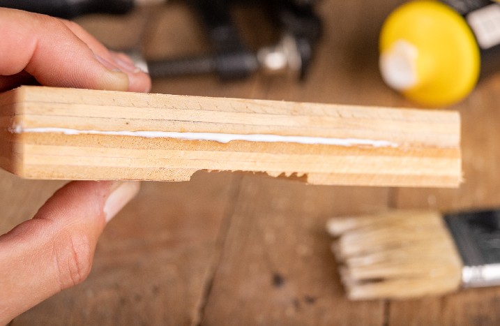 Holzkleber läuft zwischen zwei Holzplatten über