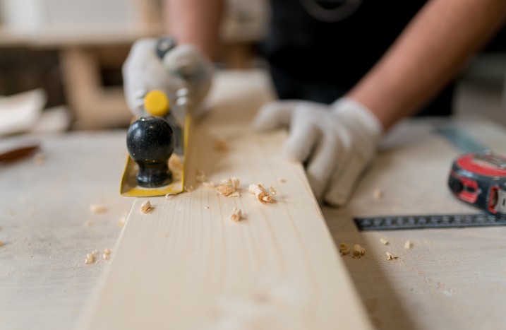 Nahaufnahme von einem Mann, der Holz hobelt