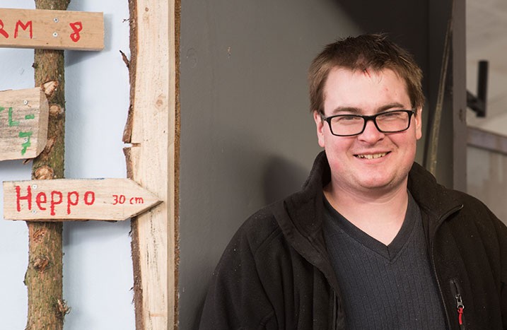 Marius posiert in seiner Werkstatt vor dem Wagen.