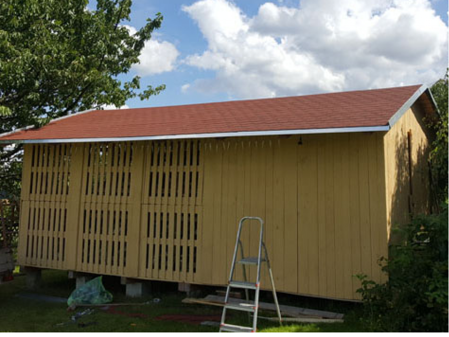 Gelbes Gartenhaus mit Lattenwänden