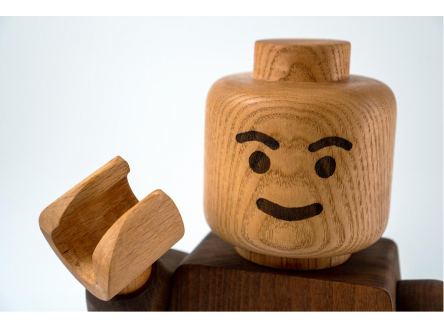 Hölzerne Figur mit hochgezogener Augenbraue