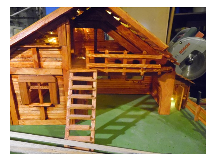 Modell eines Holzhauses mit Beleuchtung.