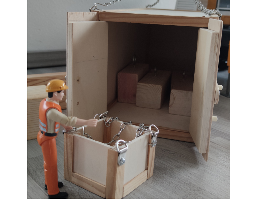 Person baut Holzkiste zusammen