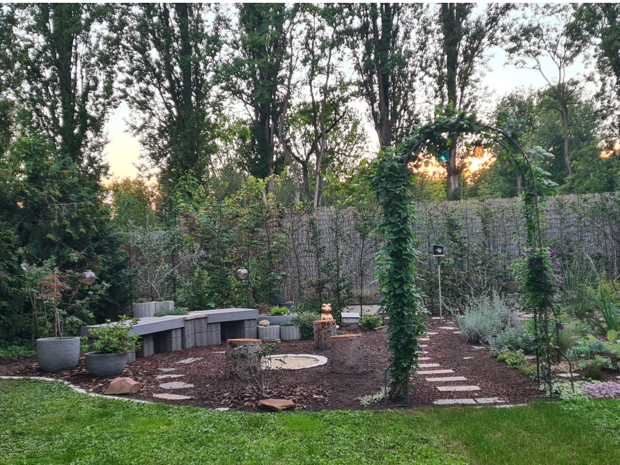 Garten mit Sitzecke und Rosenbogen