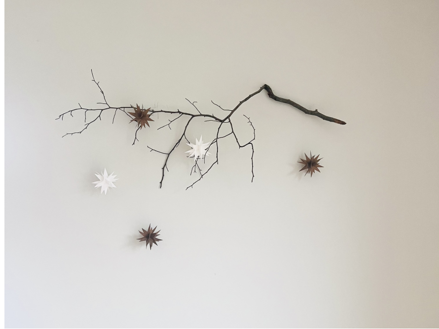 Ast mit Sternen an Wand